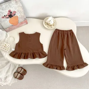 Flat lay detail of coffee brown girls' two-piece set with ruffle hem and button back