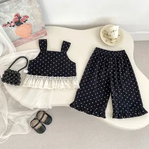 Detailed macro of floral toddler set with layered lace hem and wide-leg cotton pants