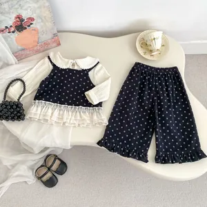 Detailed flat lay of toddler floral outfit set with lace trim and elegant accessories