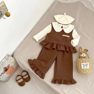 Detailed flat lay of toddler autumn outfit with ruffles and knit beret in vintage style