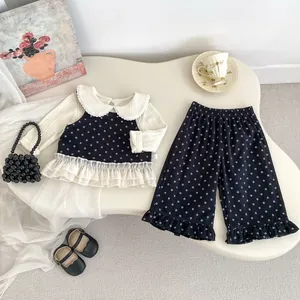 Detail of floral toddler girl three-piece set with lace trim and layered vest design