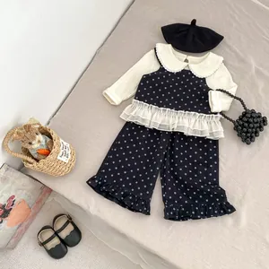 Close-up of girls' 3-piece floral set with lace doll collar and starry print pants