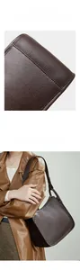 Detail of reinforced stitching on brown lychee leather hobo bag with model display