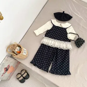 Detail view of floral toddler three-piece set with white lace ruffles and star patterns