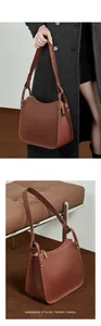 Detailed view of handmade brown leather bag with lychee texture and silver zipper accents