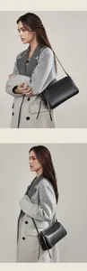 Détail du sac polochon en cuir noir avec longues tirettes à franges et texture raffinée