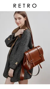 Macro detail of brown oil-wax leather backpack texture on a model wearing a grey coat