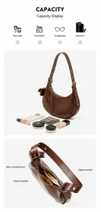 Detailed view of crocodile pattern crescent bag interior structure and storage capacity