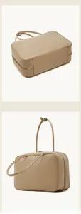 Detailed bottom and 45-degree side views of the beige leather Boston handbag