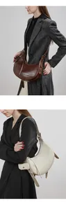 Detail view of croc-embossed leather hobo bags with adjustable straps and coin pouches