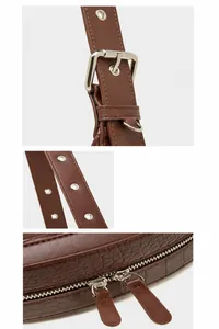 Detail of adjustable shoulder strap with silver buckle and brown crocodile texture leather