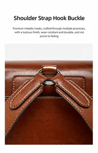 Detail showing the metal hook and stitching on the brown leather shoulder bag strap