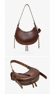 Detailed back and bottom view of brown crocodile texture leather crescent shoulder bag