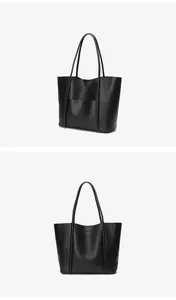 Detailed close-up of large black leather tote bag with shoulder straps and front pocket