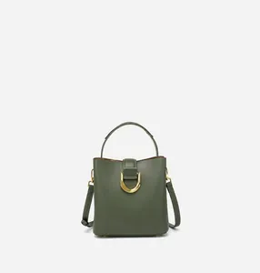 Détail du sac seau vert foncé avec bandoulière réglable et boucle dorée en forme de D