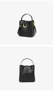Détail du sac seau noir montrant la boucle dorée en D et la bandoulière réglable