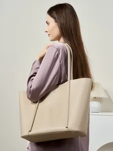 Minimalist beige leather tote bag for women showing large capacity and shoulder strap