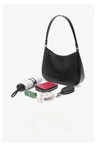 Internal capacity of the black leather hobo bag showing essentials and silver branding