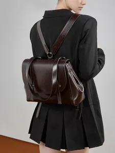 Classic dark brown oiled leather backpack for women shown on model for daily commuting