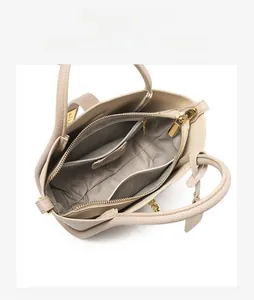 Interior view of leather bucket bag showing three compartment storage and gold zippers