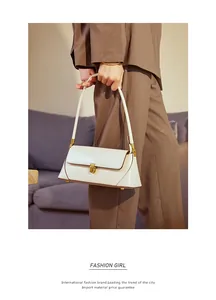 Detailed side view of off-white leather baguette bag with premium golden clasp hardware