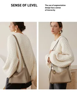 Détail d'un sac bandoulière en cuir grainé kaki avec ouverture incurvée et fine bandoulière