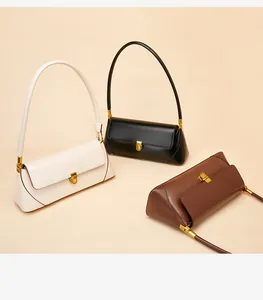 Detailed overhead view of minimalist leather baguette bags in white, black, and brown leather