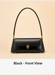 Front view of black leather baguette bag with golden handle and metallic lock detail