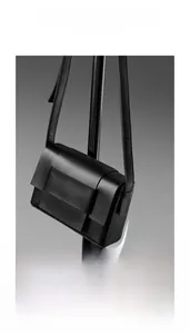 Detail of premium black cowhide leather bag featuring a bold square leather buckle
