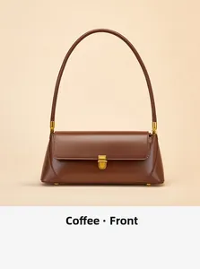 Front view of coffee brown leather baguette bag with elegant golden clasp and slim strap
