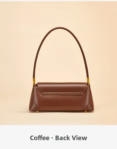 Detail view of the back of a coffee brown leather baguette bag with stitching