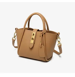 Close-up of pebble leather bucket bag with gold hardware and detachable shoulder strap