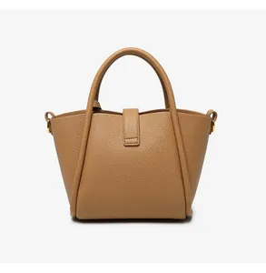 Close-up of camel leather bucket bag showing premium pebbled texture and metal rings