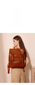 Macro detail of caramel brown matte leather texture and retro buckle on backpack