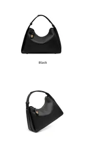 Gros plan détaillé du sac hobo en cuir noir avec surpiqûres blanches contrastées
