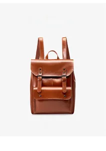 Macro detail of brown vintage leather backpack with front pocket and buckle closure