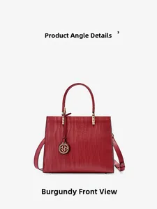 Front view of burgundy genuine leather handbag with fine wave embossing and gold hardware