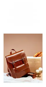 Detailed view of brown vintage leather backpack with dual buckles and front pocket