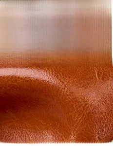 Close-up of premium textured cowhide leather with a rich caramel brown finish