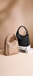 Detail of leather tote bags with unique origami fold structure and silver metal buckle