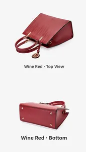 Detail view of burgundy leather handbag showing top zipper closure and protective base studs