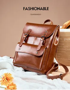 Detail view of the vintage leather backpack with buckle straps and stylish magnetic flap