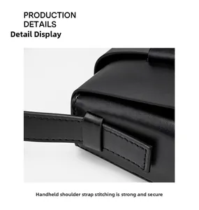 Close-up of reinforced stitching on the leather shoulder strap for enhanced durability