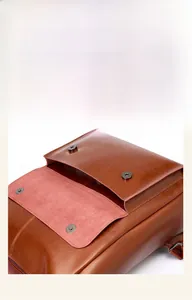 Detail of vintage brown leather backpack with metal buckle and external pocket