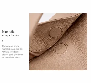 Close-up of magnetic buckle closure and lychee grain leather texture on a beige handbag