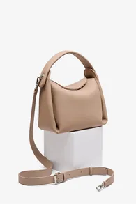 Detail of lychee pattern leather handbag with silver hardware and adjustable strap