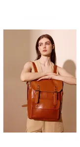 Retro leather backpack featuring double buckle straps and large front pocket detail