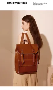 Detailed side view of a large vintage brown leather backpack with retro buckle straps