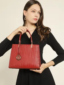 Elegant deep red leather handbag with vertical wave texture and gold hardware details