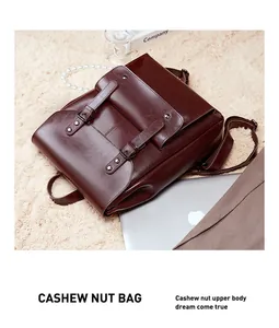 Close-up of vintage dark brown leather backpack with metal buckles on plush carpet